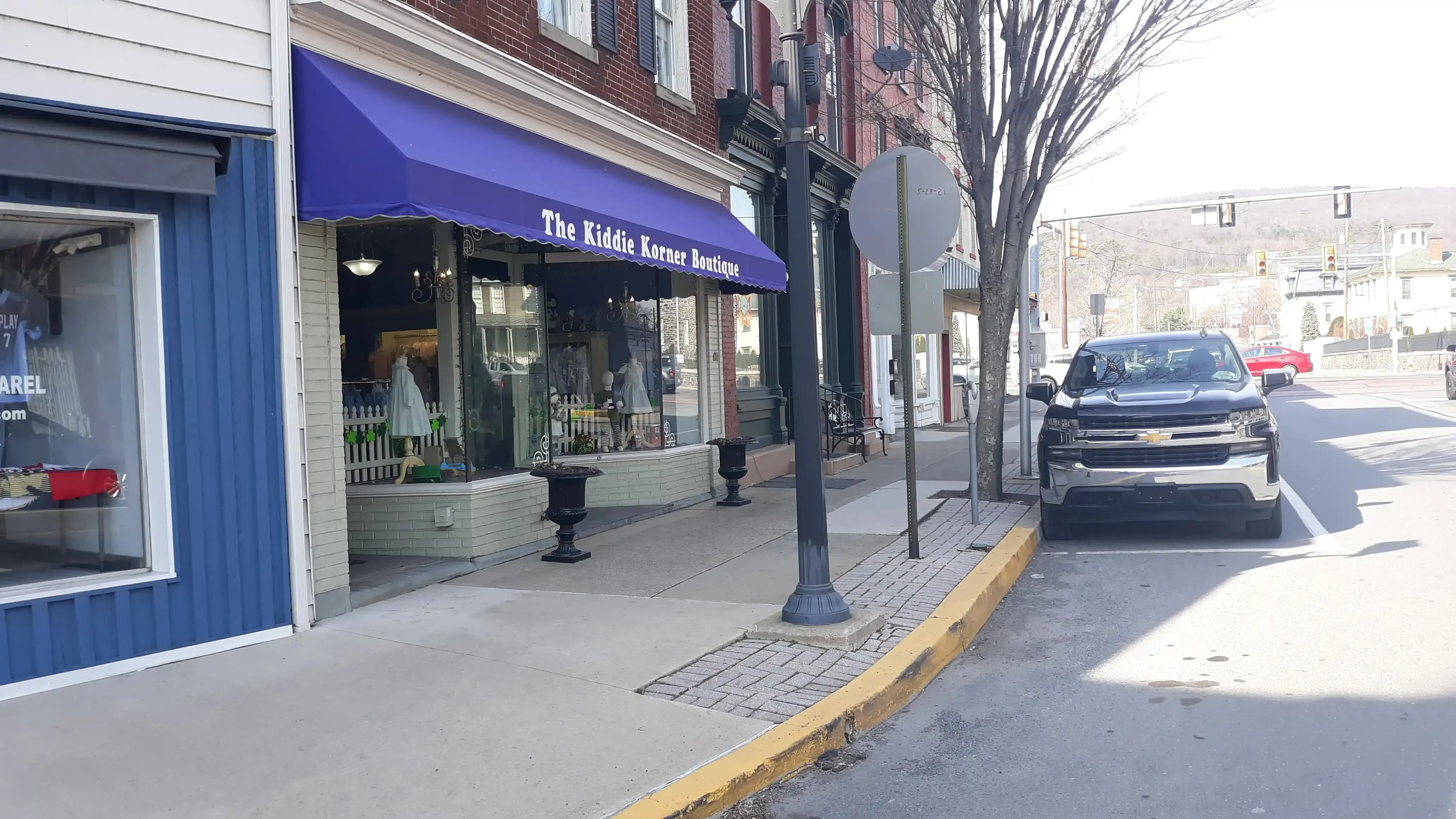 The Kiddie Korner Boutique storefront with its purple awning on Mill Street, Danville
