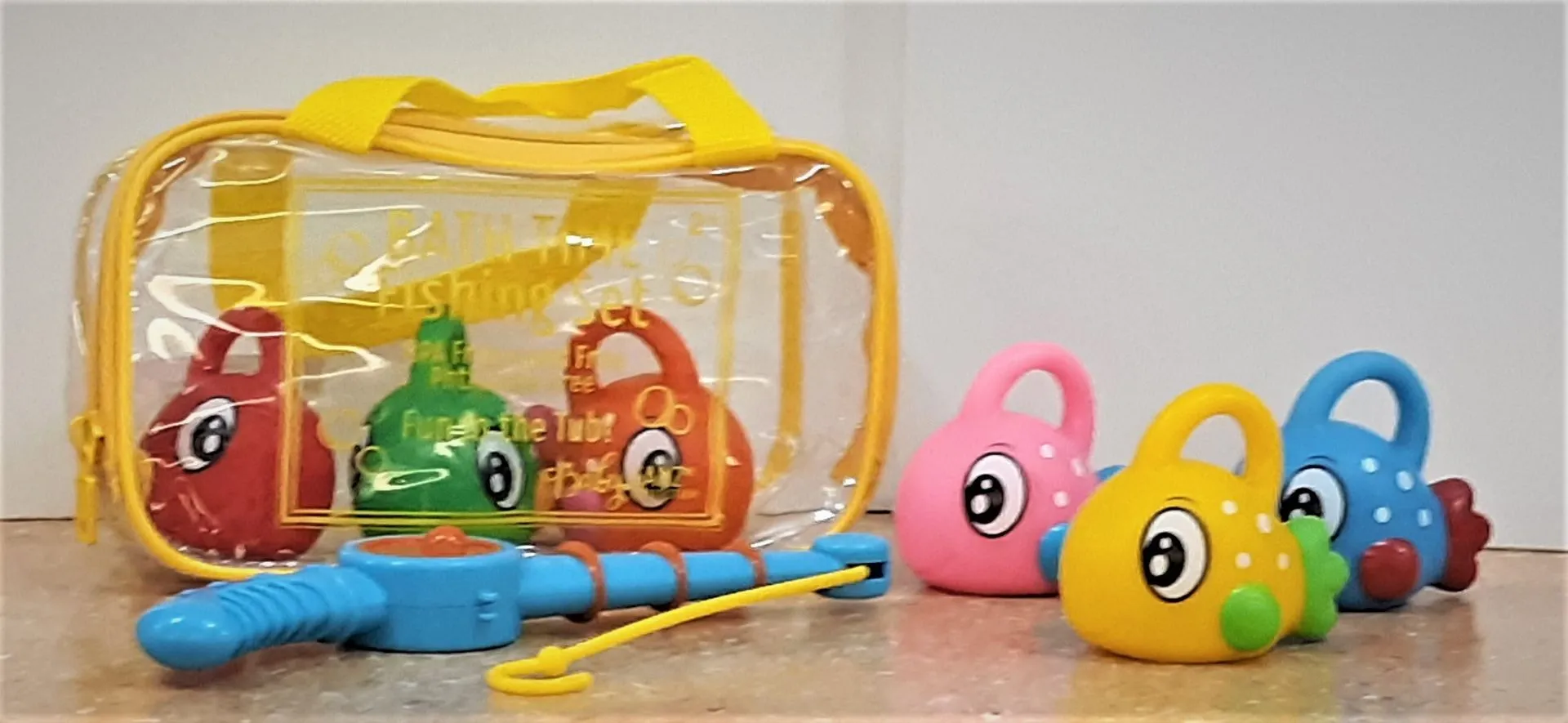 Toy fishing set with a rod and colorful fish in a clear zippered bag